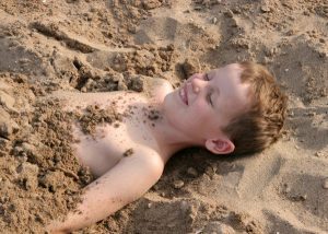 Burying a sibling on the beach