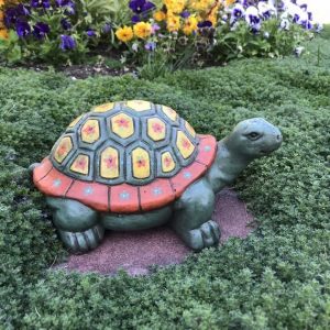 turtle statue in the garden with plants