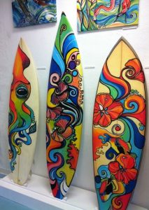 Surfboards with art drawn on them